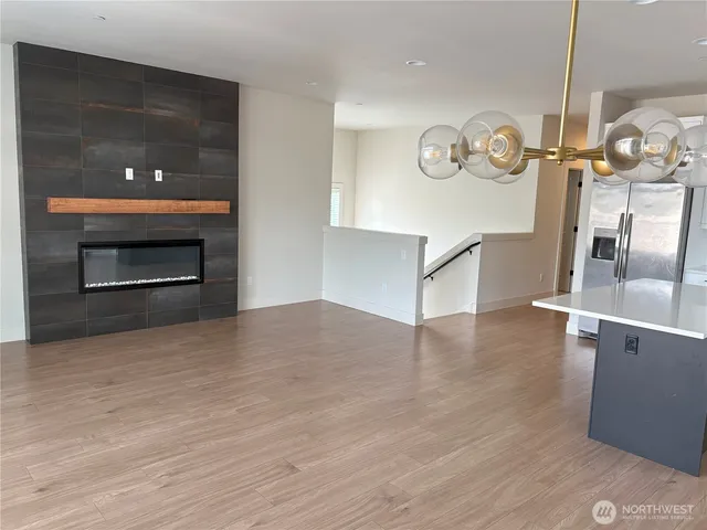 a view of a kitchen center island wooden floor and stove