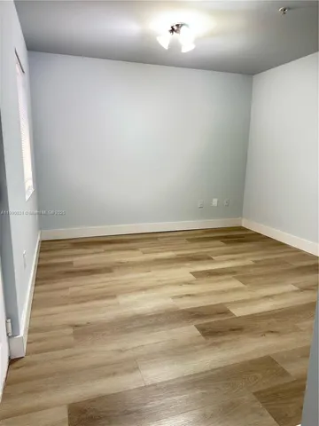 a view of room with wooden floor