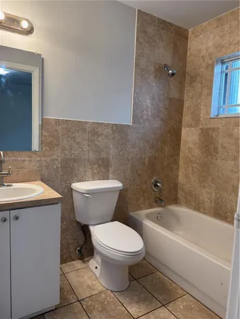 a bathroom with a toilet a sink and bathtub