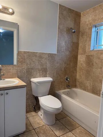 a bathroom with a toilet a sink and bathtub