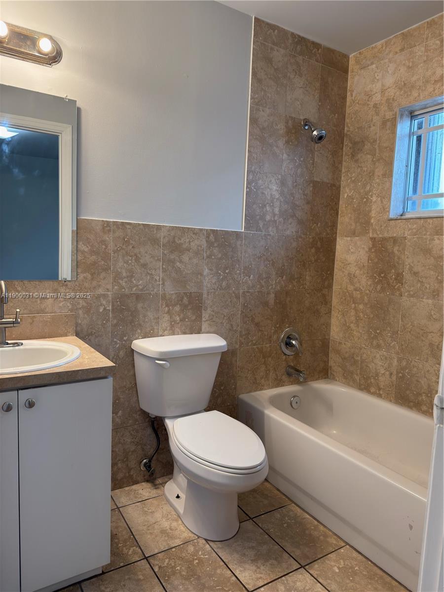 1930 Southwest 2nd Street, Unit 6 Miami, FL 33135 - Photo 5 of 6 a bathroom with a toilet a sink and bathtub