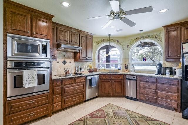 103 Ridgeway Gap Ovilla, TX 75154 - Photo 18 of 40 a kitchen with stainless steel appliances granite countertop a stove and cabinets