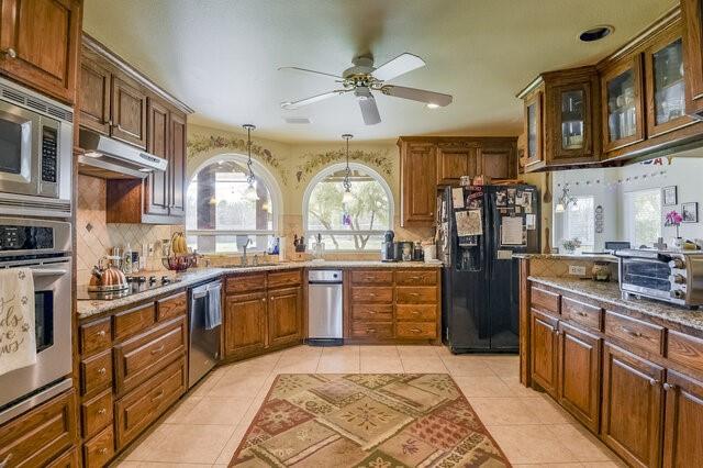 103 Ridgeway Gap Ovilla, TX 75154 - Photo 20 of 40 a large kitchen with stainless steel appliances granite countertop a sink and cabinets