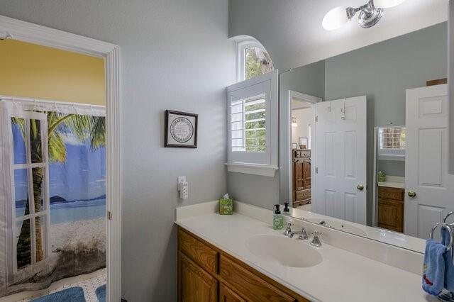 103 Ridgeway Gap Ovilla, TX 75154 - Photo 27 of 40 a bathroom with a sink vanity and a mirror
