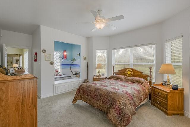 103 Ridgeway Gap Ovilla, TX 75154 - Photo 29 of 40 a bedroom with a bed and a chandelier