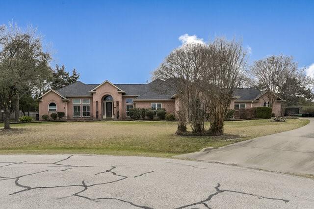 103 Ridgeway Gap Ovilla, TX 75154 - Photo 3 of 40 a front view of a house with a garden and trees