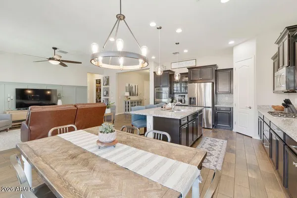 a large kitchen with a table and chairs