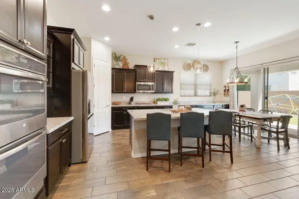 a large kitchen with a table and chairs