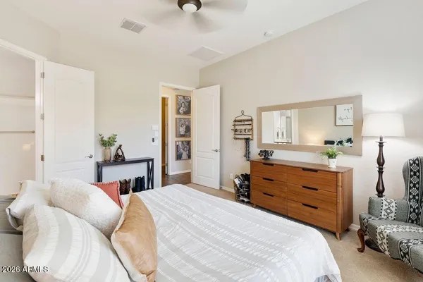 a bedroom with a bed and a dresser