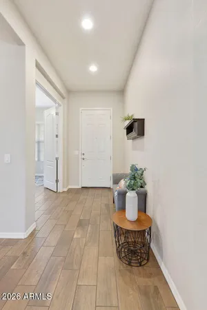 a room with a potted plant and kitchen view