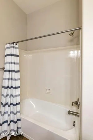 a bathroom with a shower and a bath tub