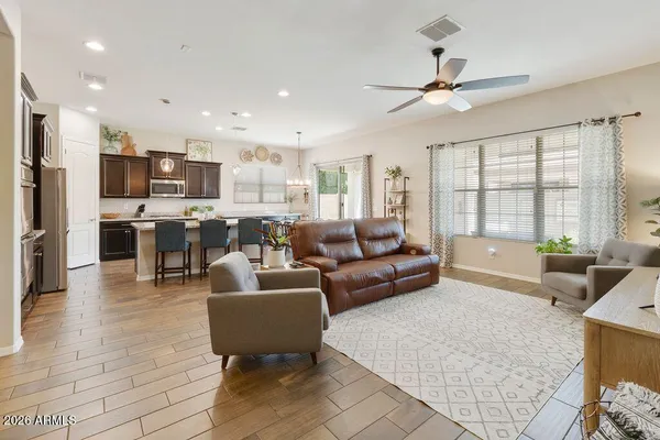 a living room kitchen with furniture and a large window