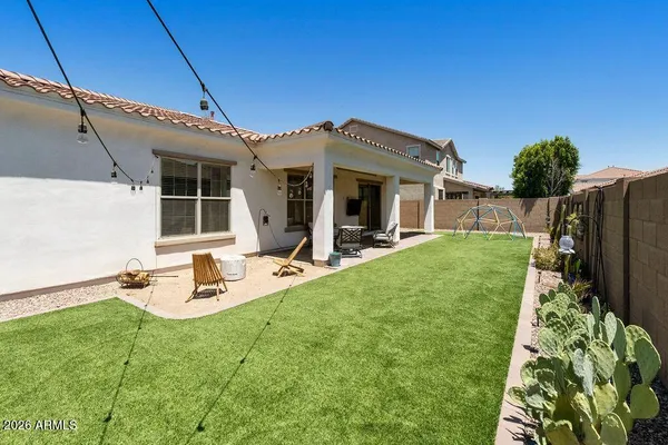 a view of a house with backyard porch and furniture