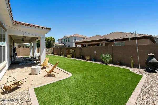 a view of a patio with a dining table and chairs under an umbrella