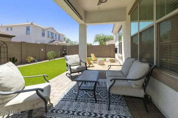 a view of a patio with table and chairs and potted plants