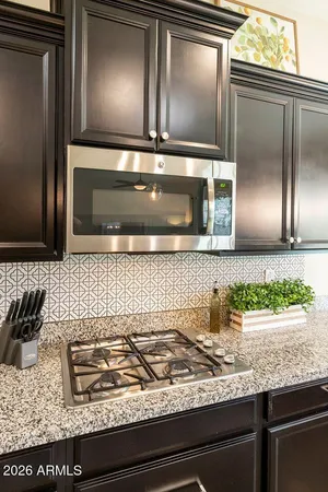 a kitchen with granite countertop stainless steel appliances and cabinets