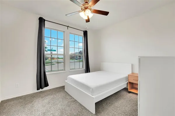 a bedroom with a bed and window