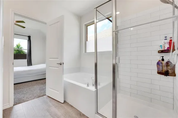 a bathroom with a bathtub and a shower