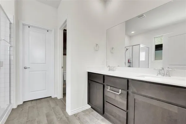 a bathroom with a double vanity sink mirror and