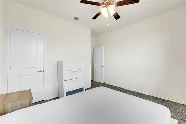 a bedroom with a bed and cabinets