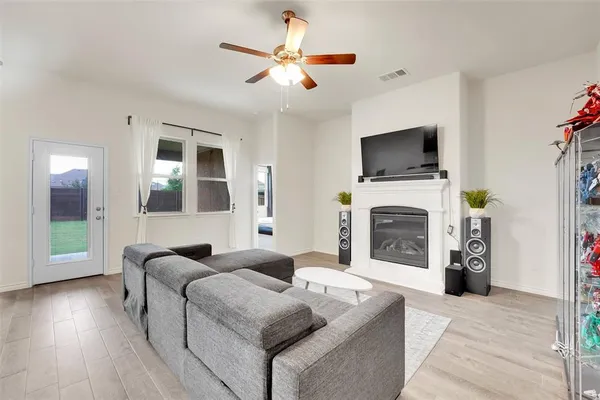 a living room with furniture a flat screen tv and a fireplace