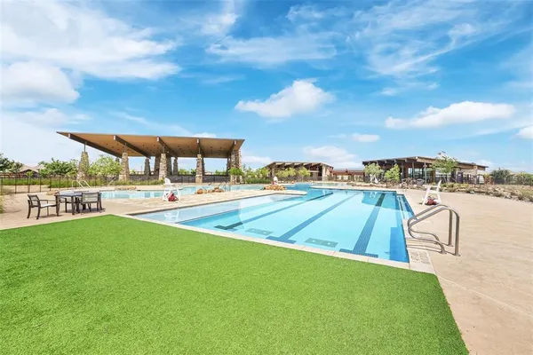 a view of a swimming pool with an outdoor seating