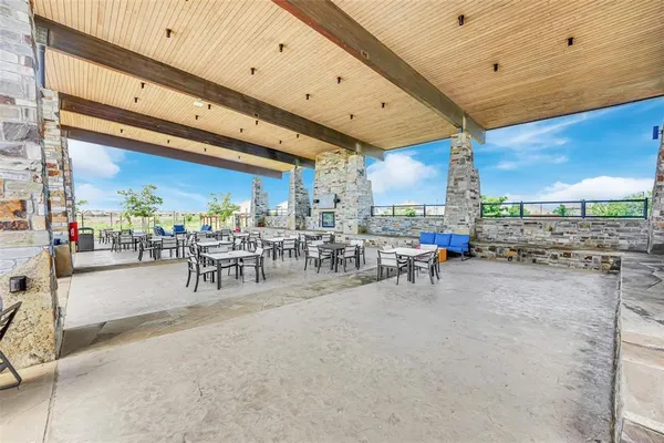 a view of a patio with dining table and chairs