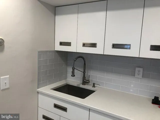 a kitchen with a sink and cabinets