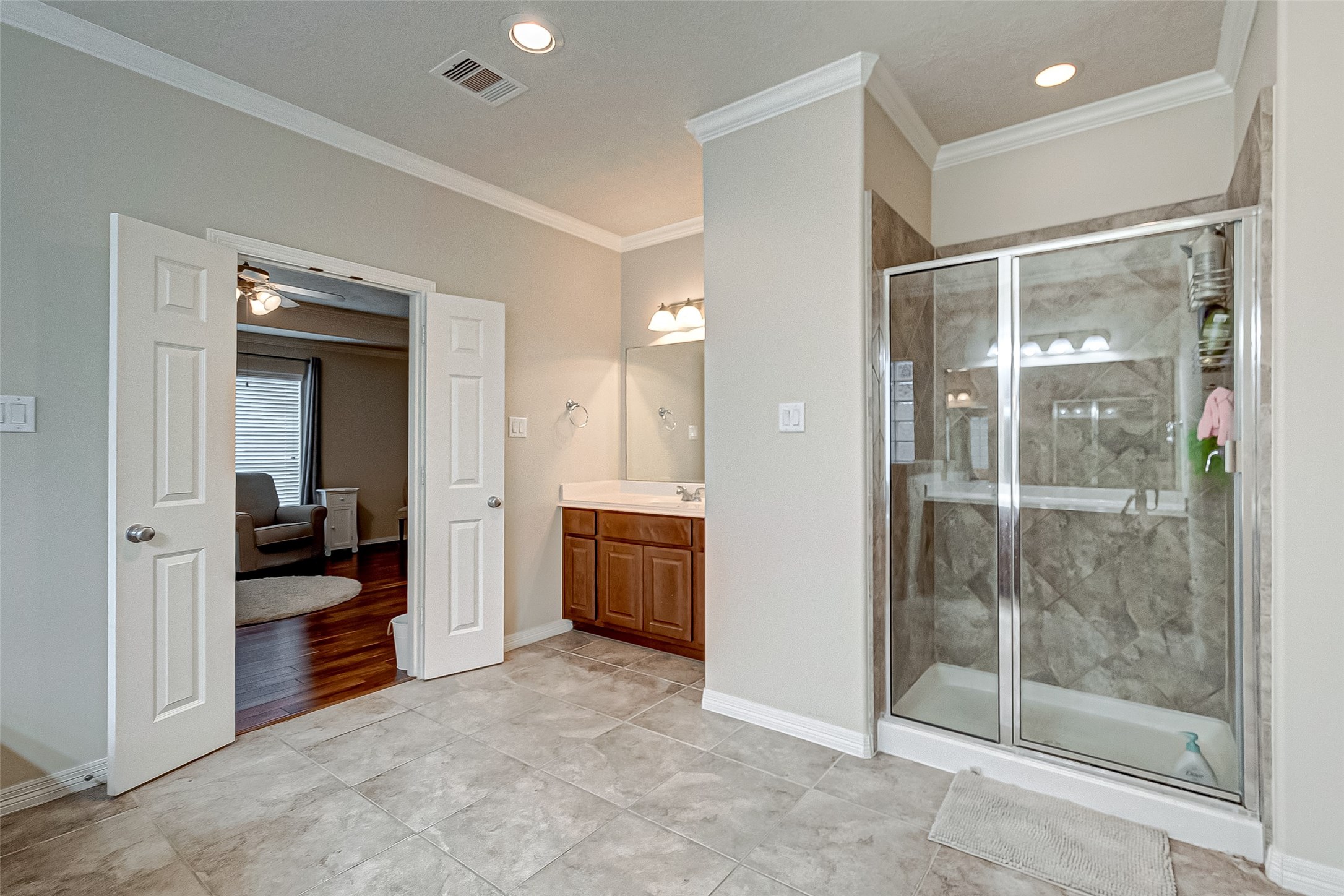 14418 Basalt Lane Houston, TX 77077 - Photo 21 of 32 a bathroom with a glass shower door and a sink