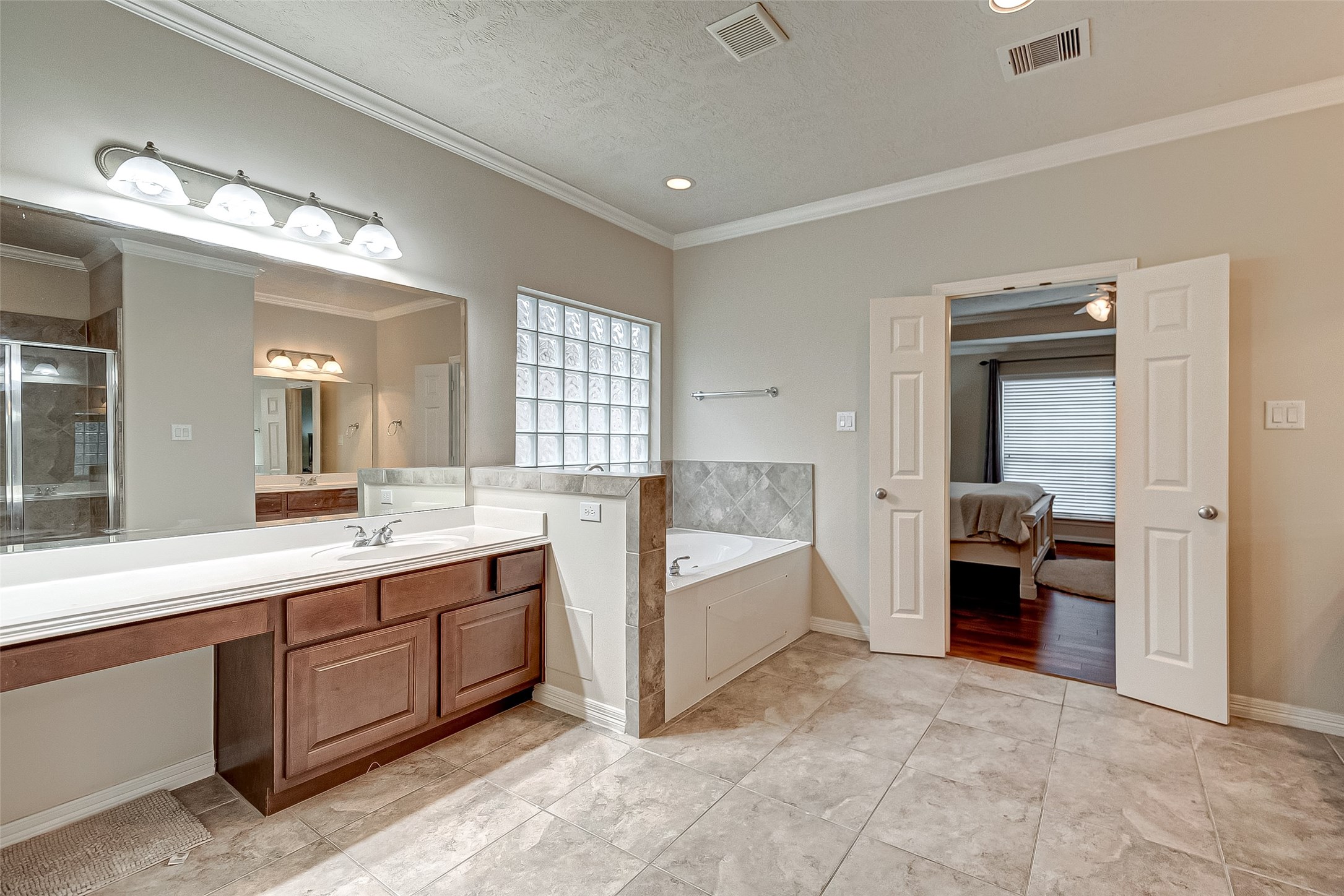 14418 Basalt Lane Houston, TX 77077 - Photo 22 of 32 a large white room with a large mirror and sink