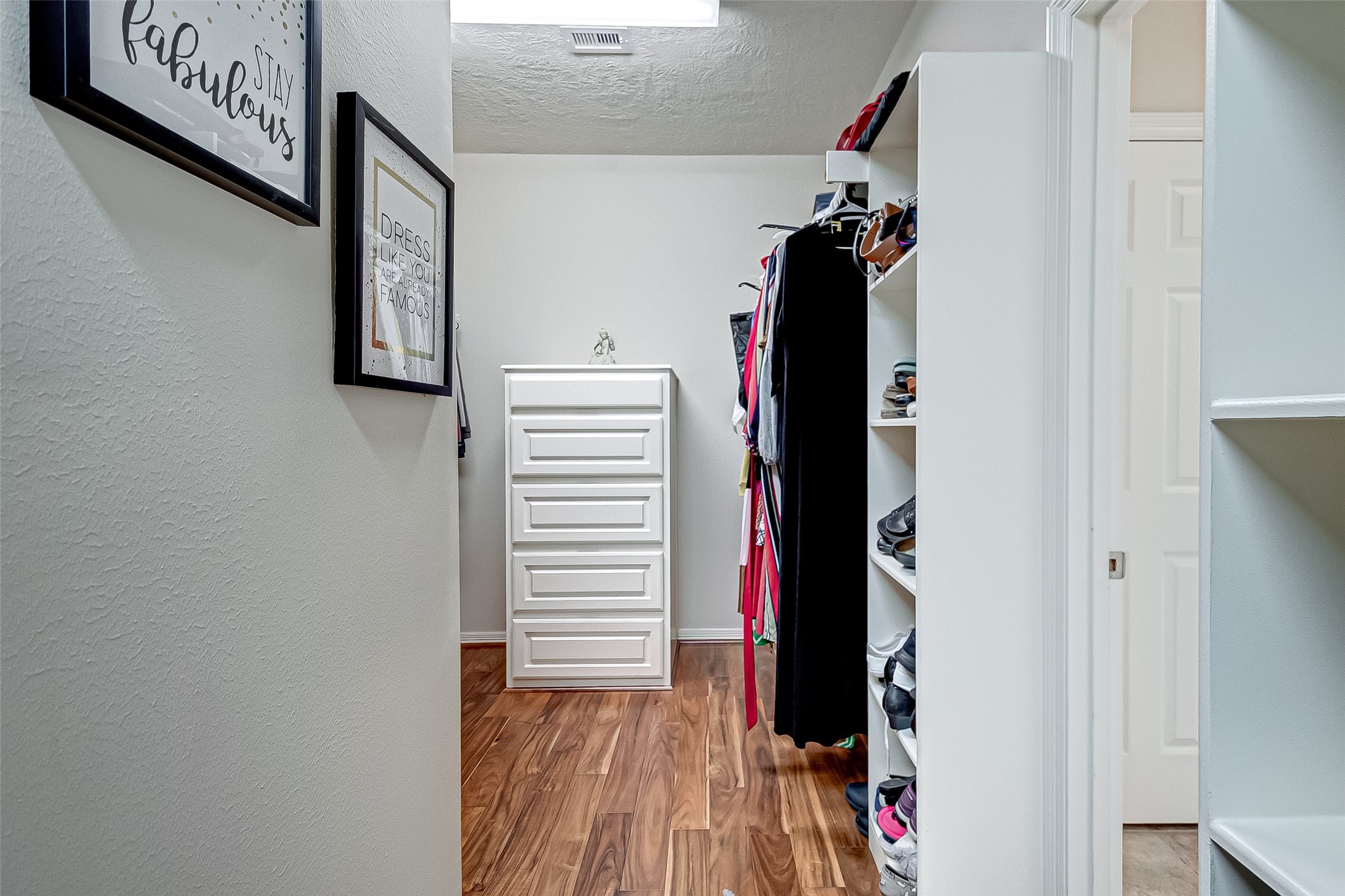 14418 Basalt Lane Houston, TX 77077 - Photo 24 of 32 a view of walk in closet with clothes