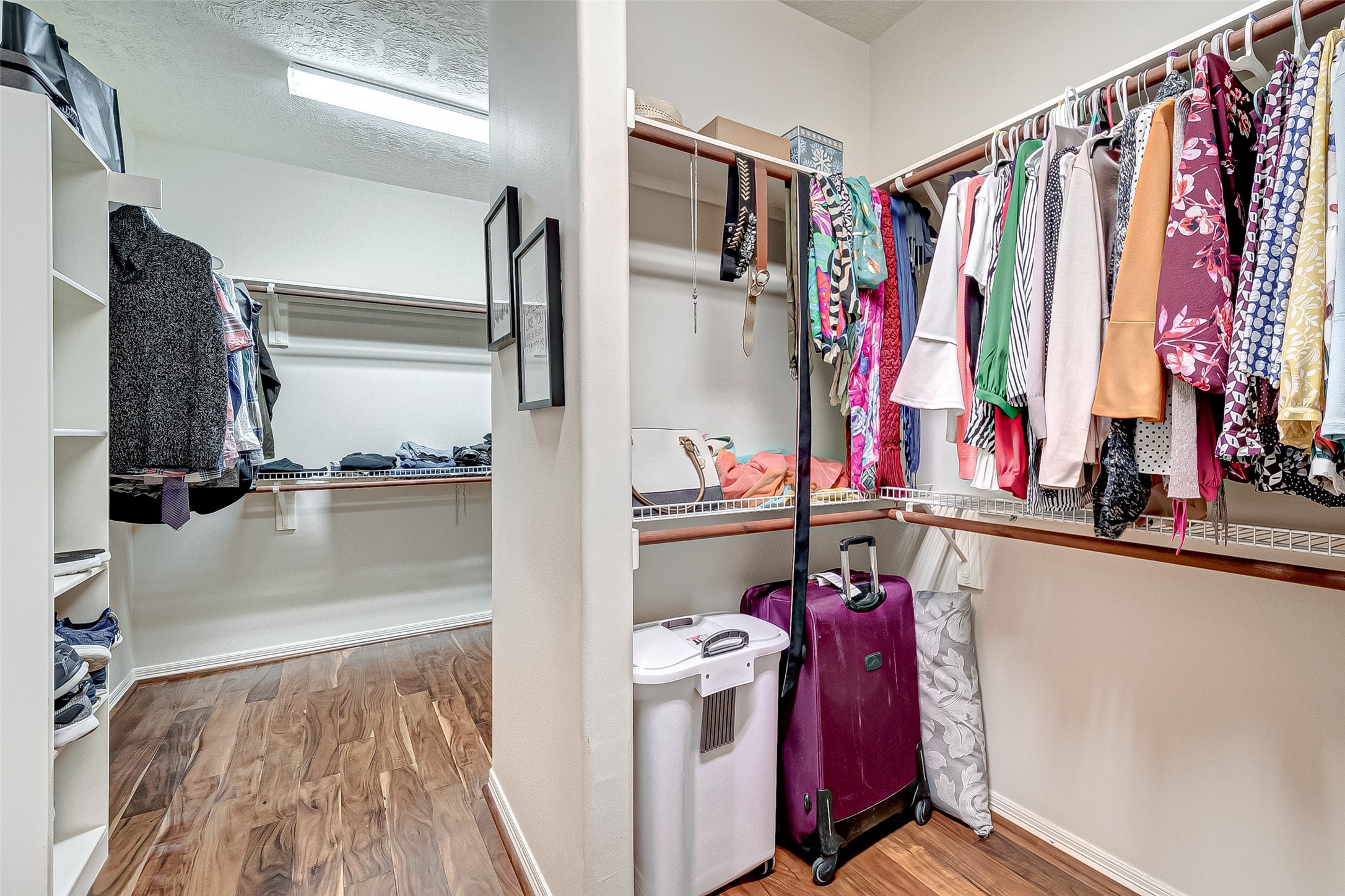 14418 Basalt Lane Houston, TX 77077 - Photo 25 of 32 a view of walk in closet with clothes and shoes