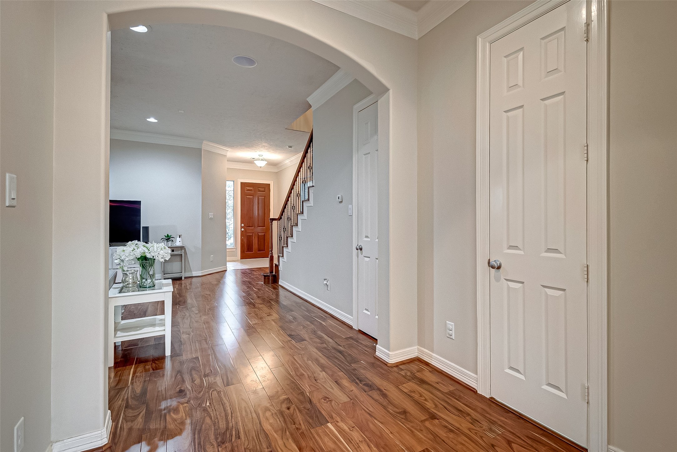 14418 Basalt Lane Houston, TX 77077 - Photo 7 of 32 a view of a hallway with wooden floor table and staircase