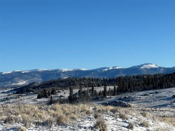 a view of a town with mountains in the background