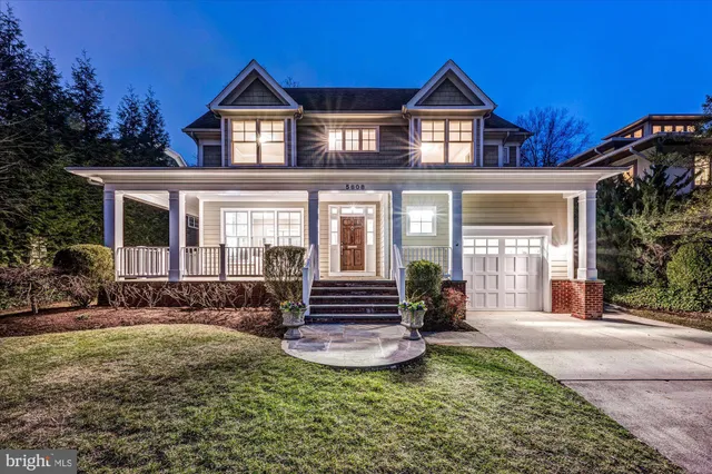 a front view of a house with yard and green space