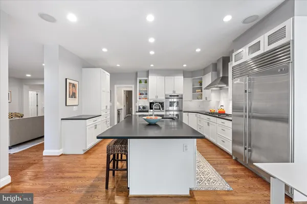 a kitchen with a refrigerator and a counter top space