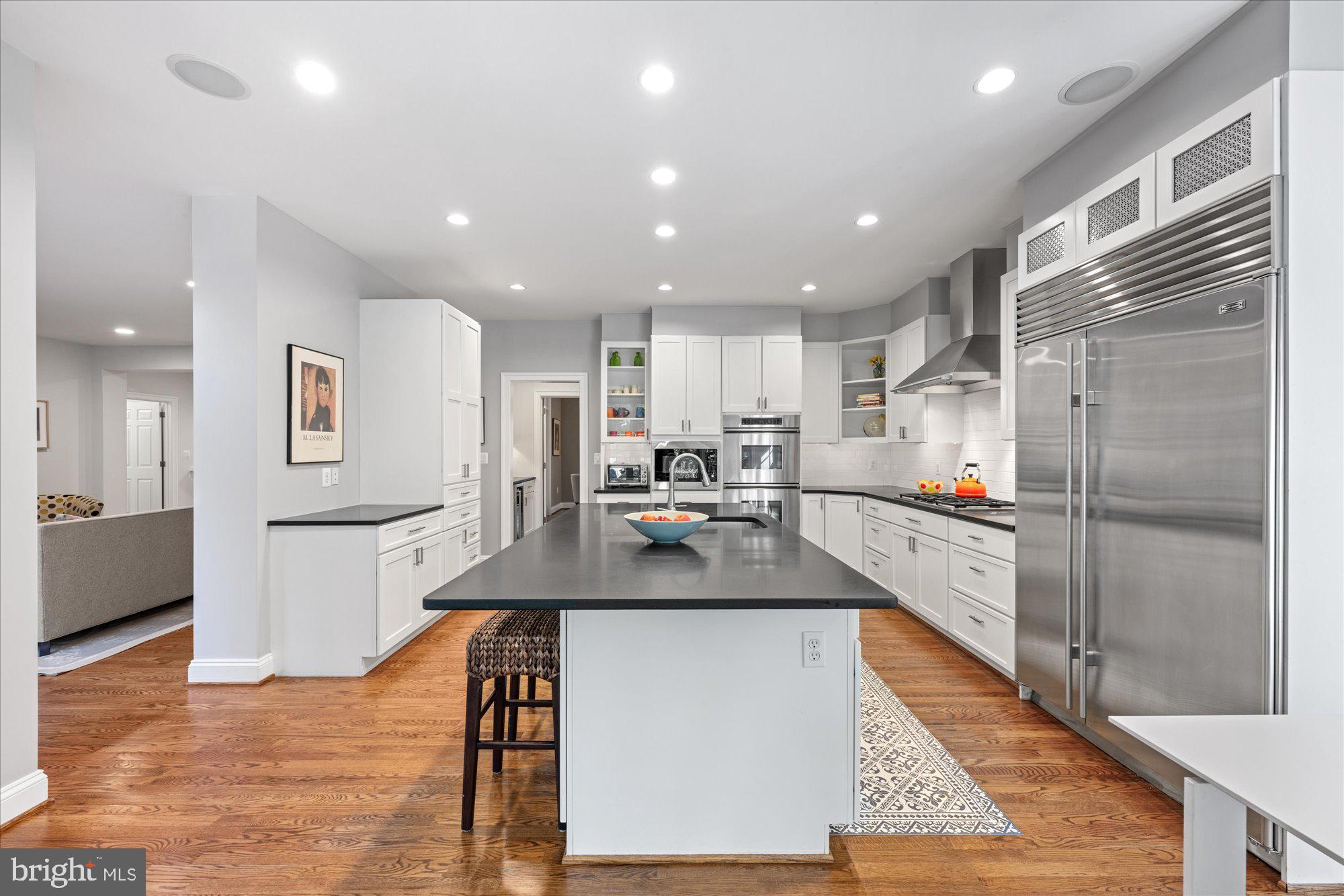 5608 Warwick Place Chevy Chase, MD 20815 - Photo 11 of 57 a kitchen with a refrigerator and a counter top space