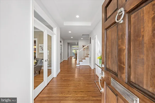 a view of a hallway with wooden floor and staircase
