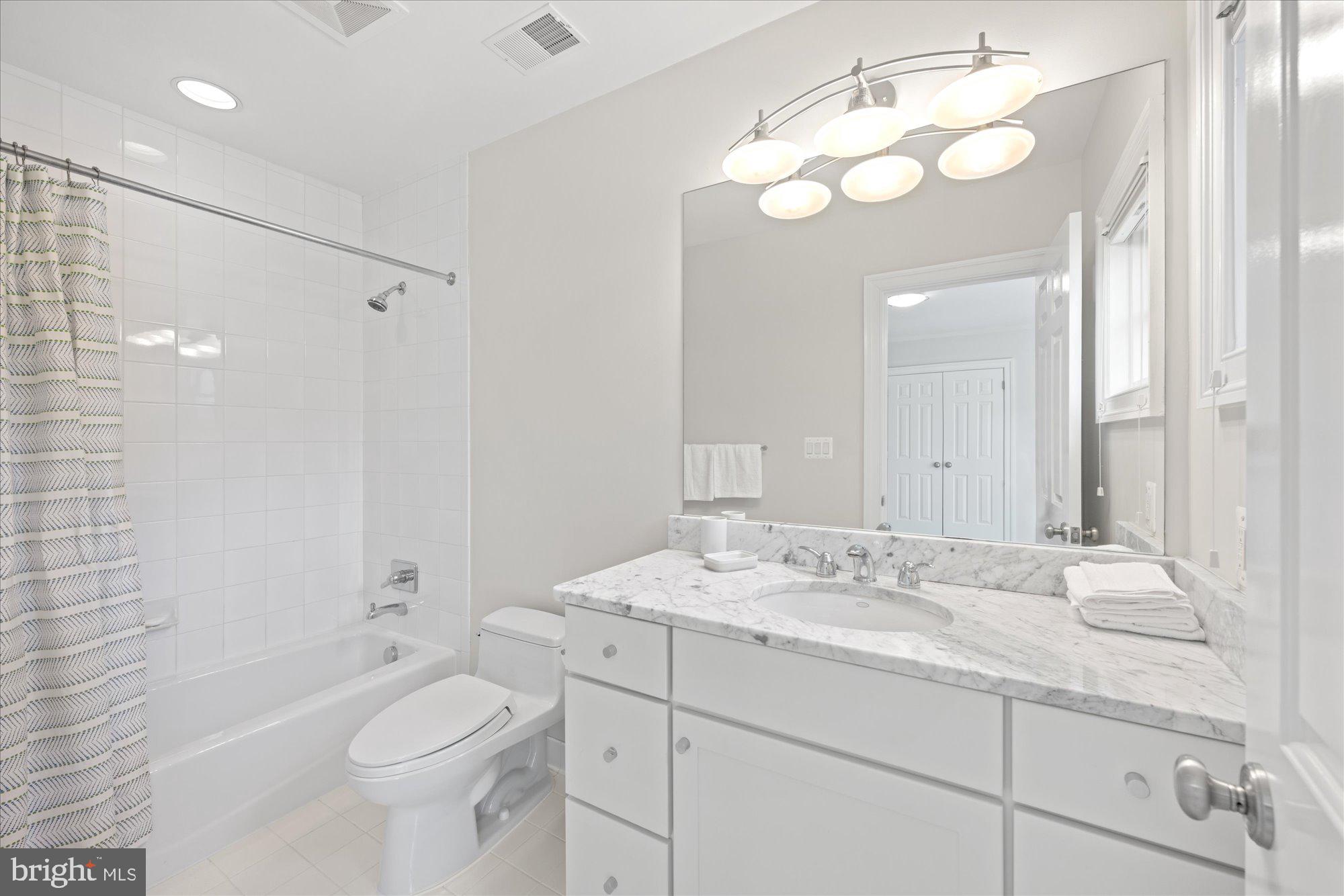 5608 Warwick Place Chevy Chase, MD 20815 - Photo 34 of 57 a bathroom with a sink a toilet and shower