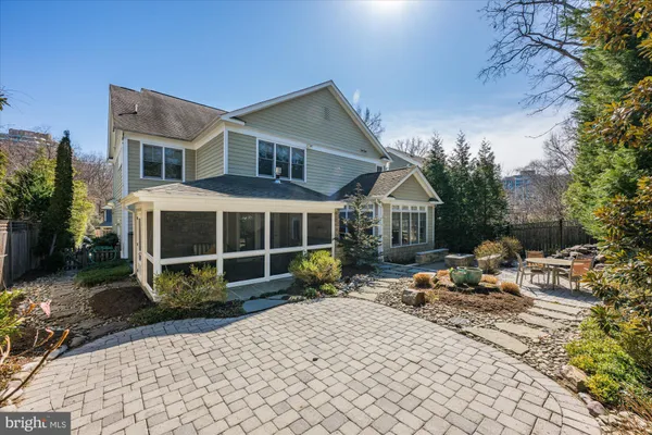 a backyard of a house with a yard and outdoor seating