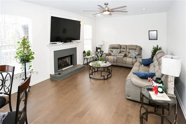 a living room with furniture kitchen view and a potted plant