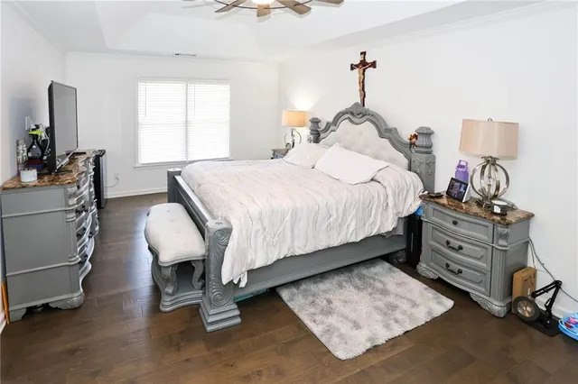 a bedroom with a bed and lamp on table