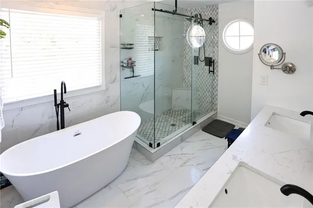 a bathroom with a shower a mirror and a sink