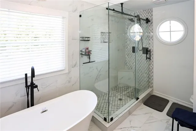 a spacious bathroom with a double vanity sink a mirror and bathtub