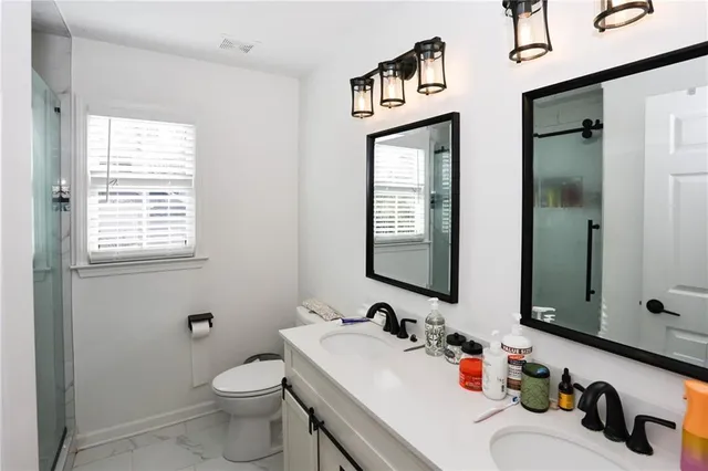a bathroom with a sink toilet and shower