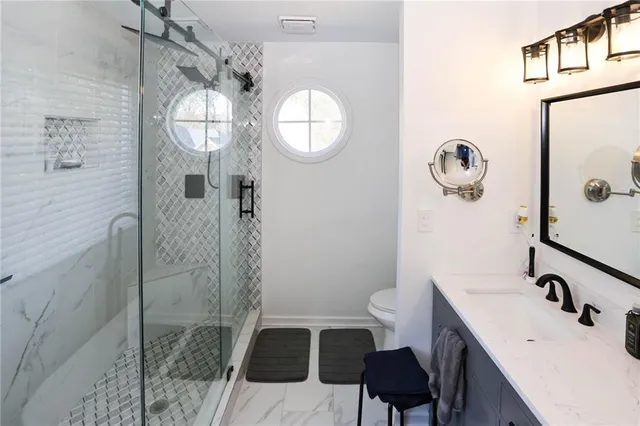 a kitchen with stainless steel appliances a refrigerator sink and cabinets