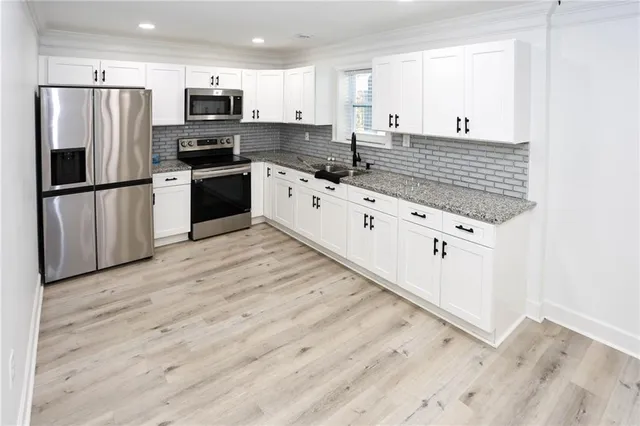 a kitchen with stainless steel appliances a refrigerator stove and microwave