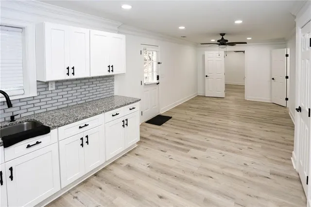 a view of a kitchen with a sink and cabinets