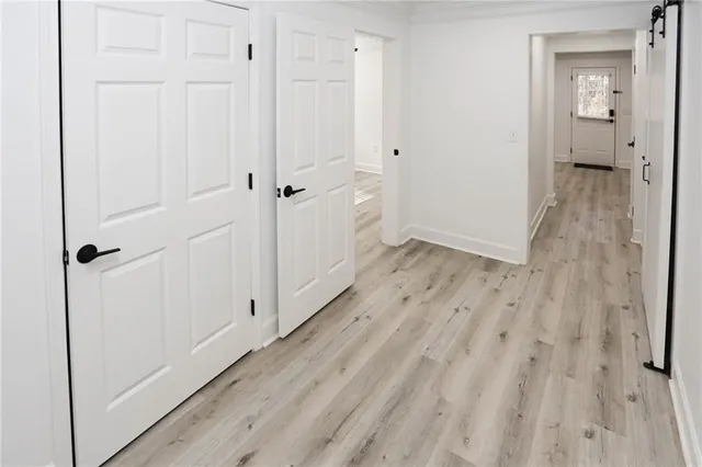 a view of a room with a ceiling fan and wooden floor