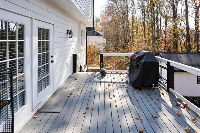 a view of balcony with wooden floor and outdoor seating
